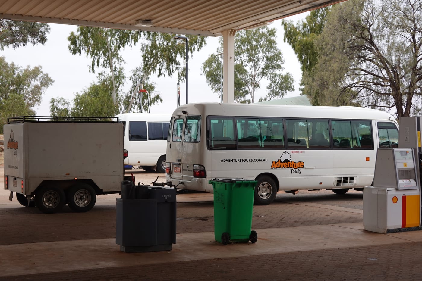 Adventure Tours bus at a fuel stop.