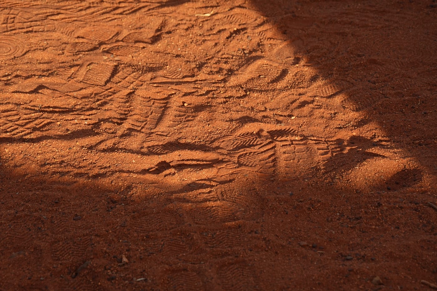 Shoe prints in red sand.